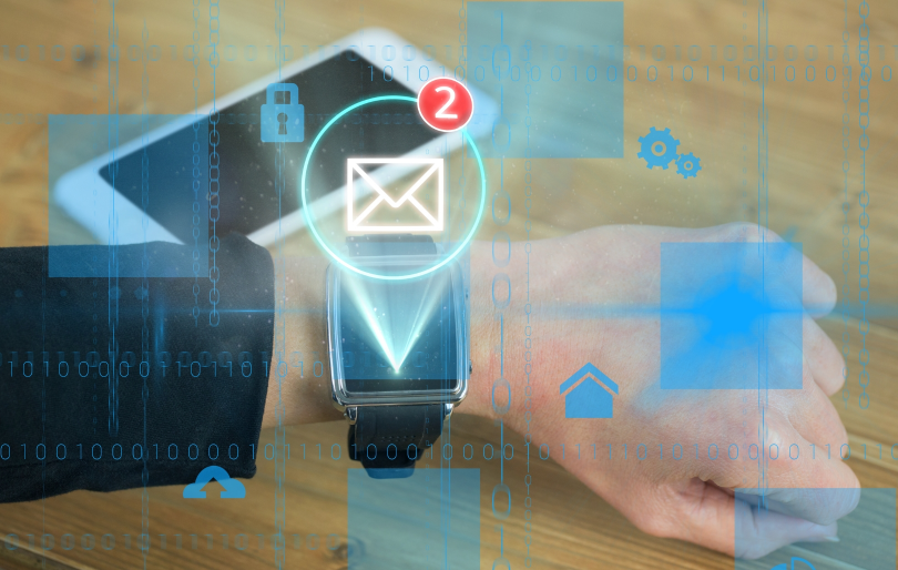 Smartwatch in Man's Hand Displaying Email Icon